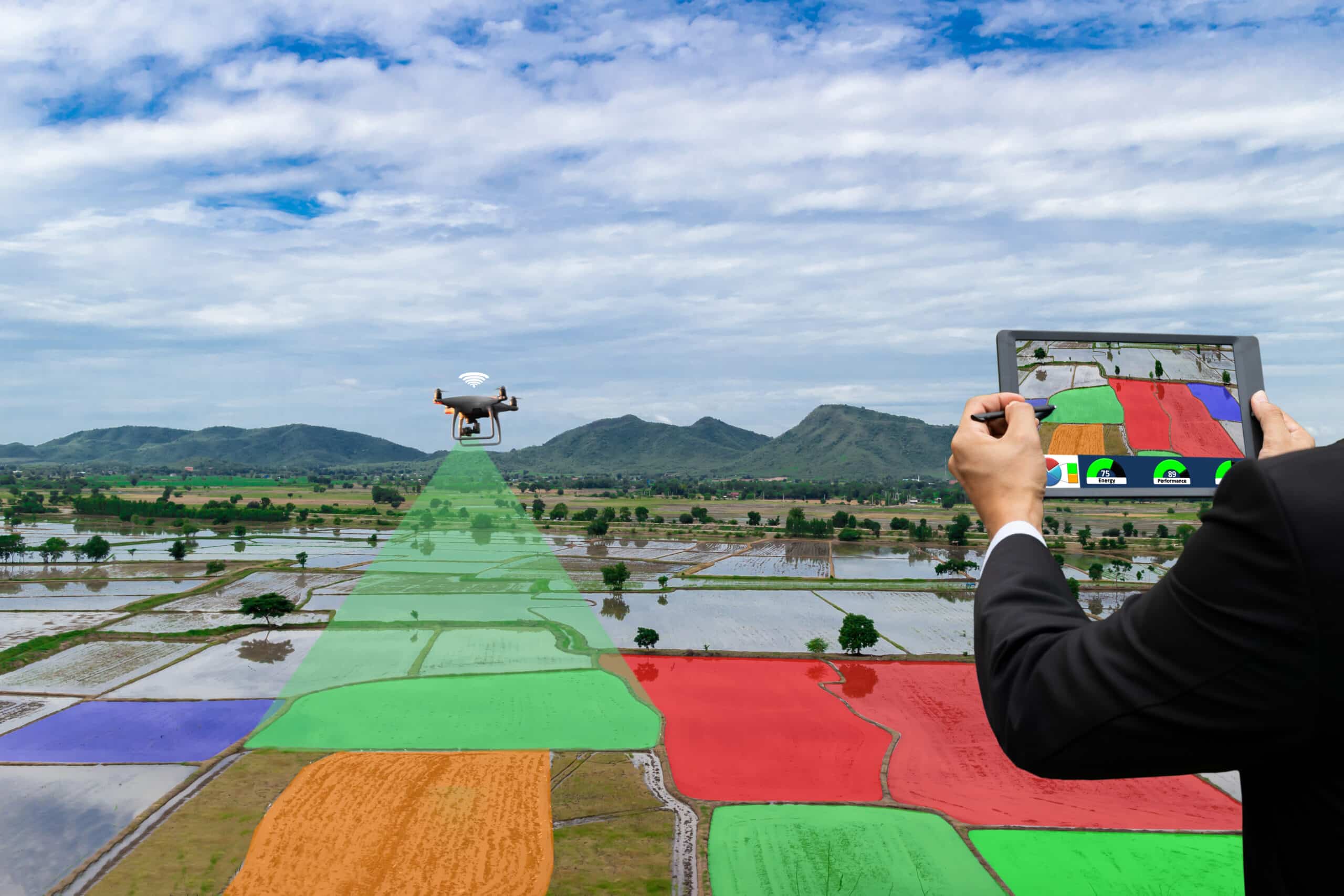 Four farmers in a lush field observing a drone spraying crops, using digital devices to analyze agricultural data.
